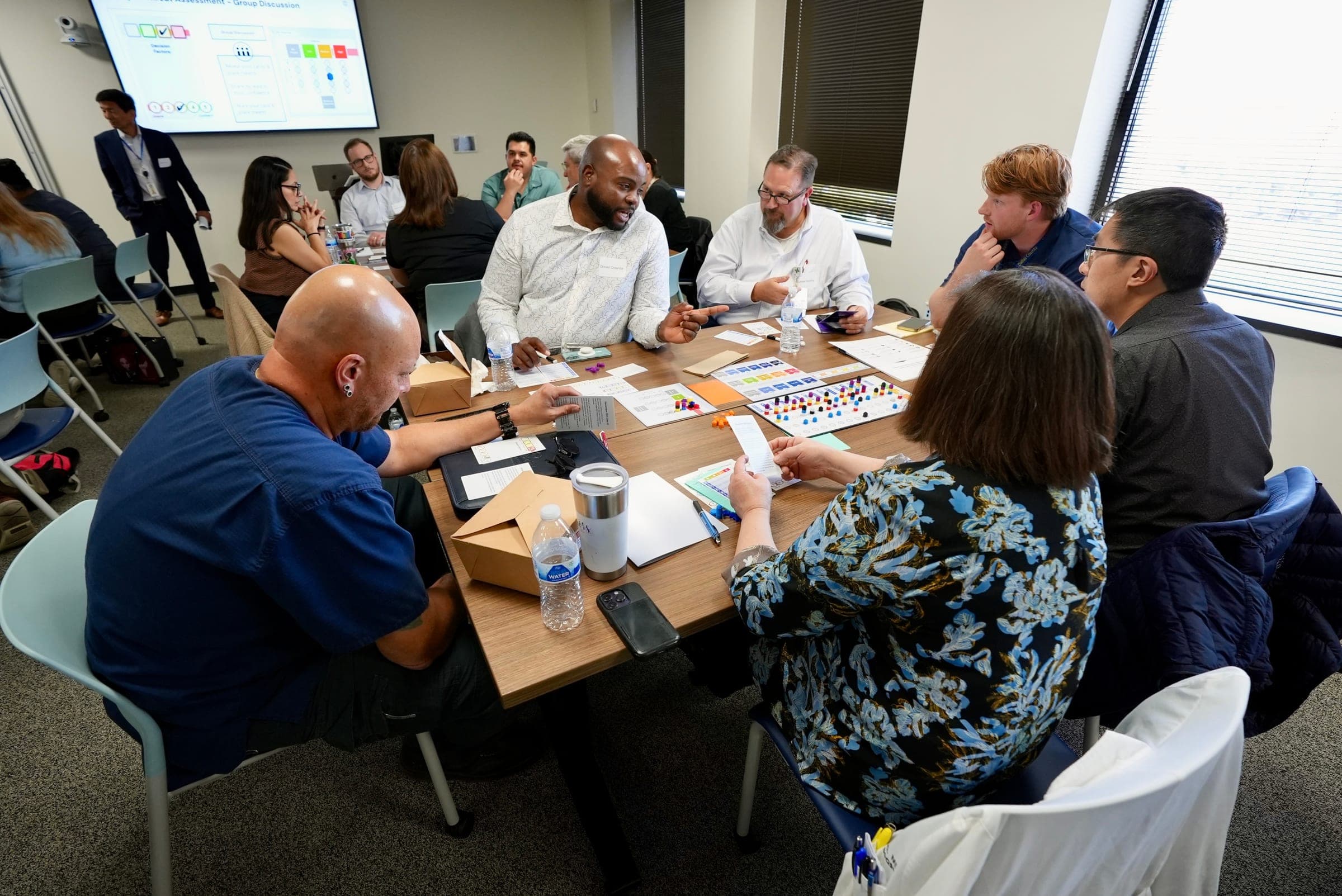 Team collaborating around game materials