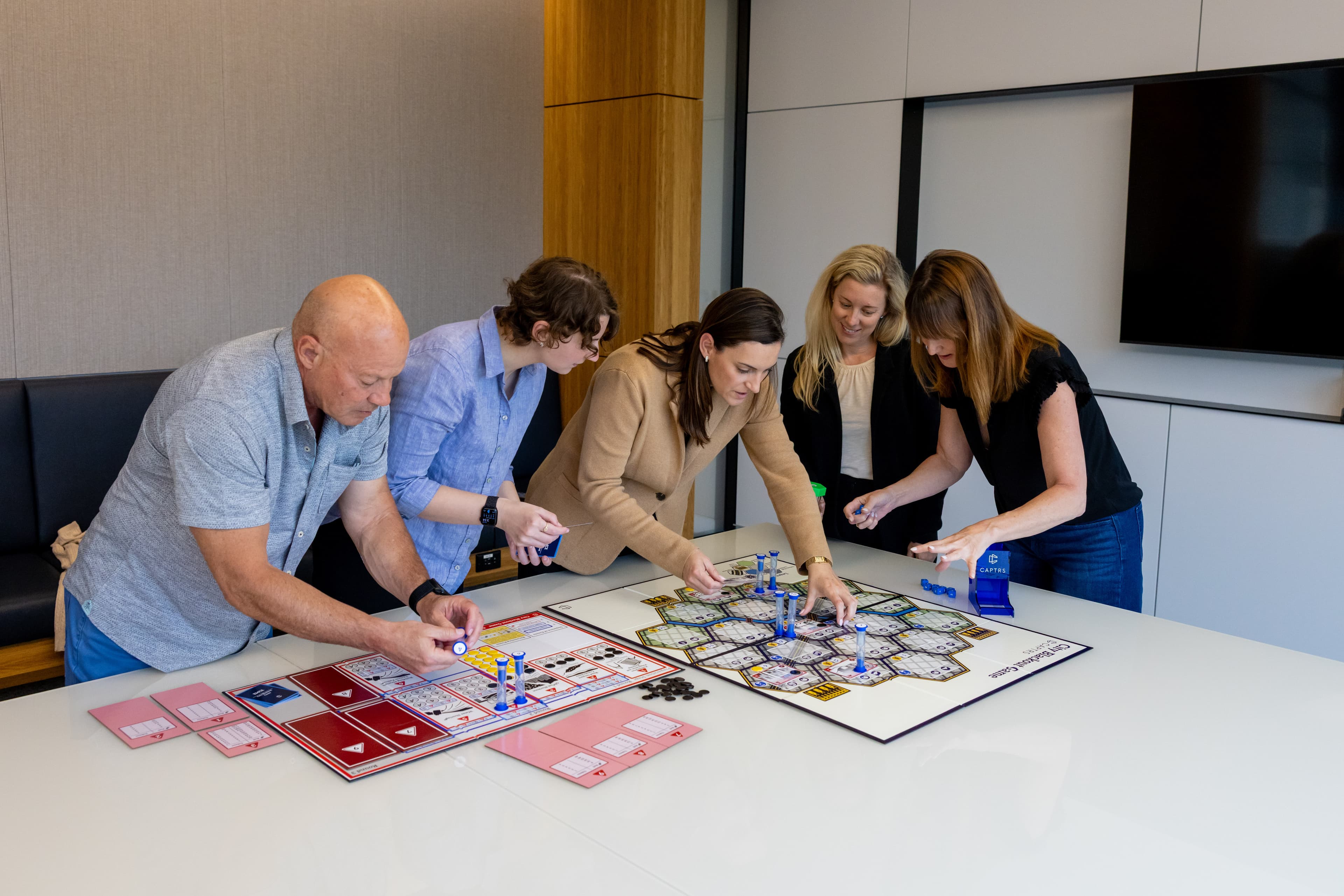 Team discussion around board game simulation